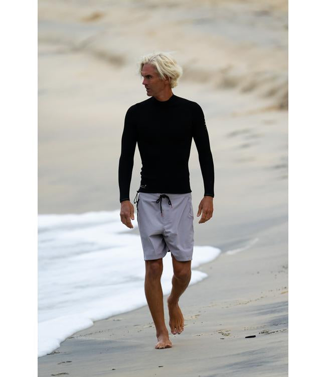 Follow P1 Mens 1mm Heater Top Black worn by a rider staying warm during an early session