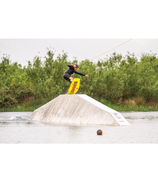 Ronix EPIC Cable Wakeboard - rider crossing the top of a white kicker with the yellow board