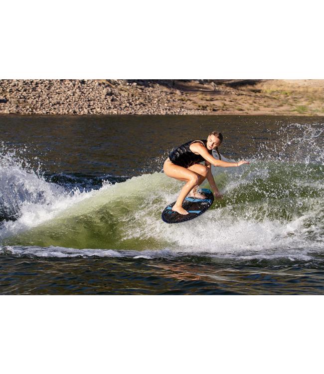 Ronix Moment Womens Skimmer - rider crouched low through a carve on the face of the wave