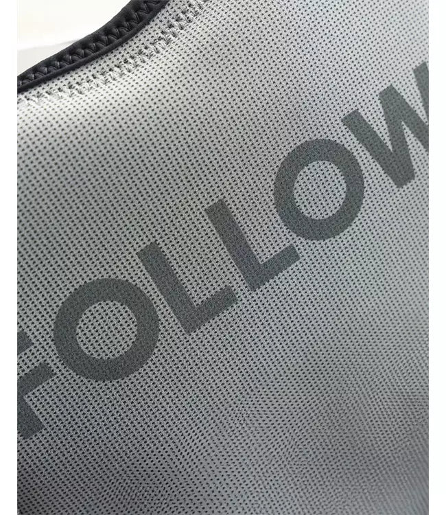 Follow Section Stone Mens Life Vest worn by a wakeboarder riding behind the boat on open water