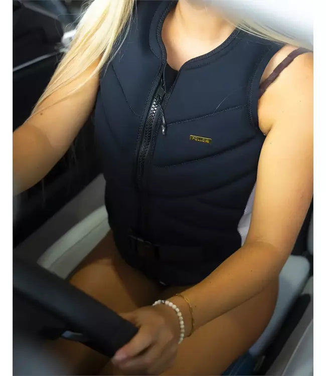 Follow Cleo Black Womens Life Vest worn by a woman riding behind the boat on open water