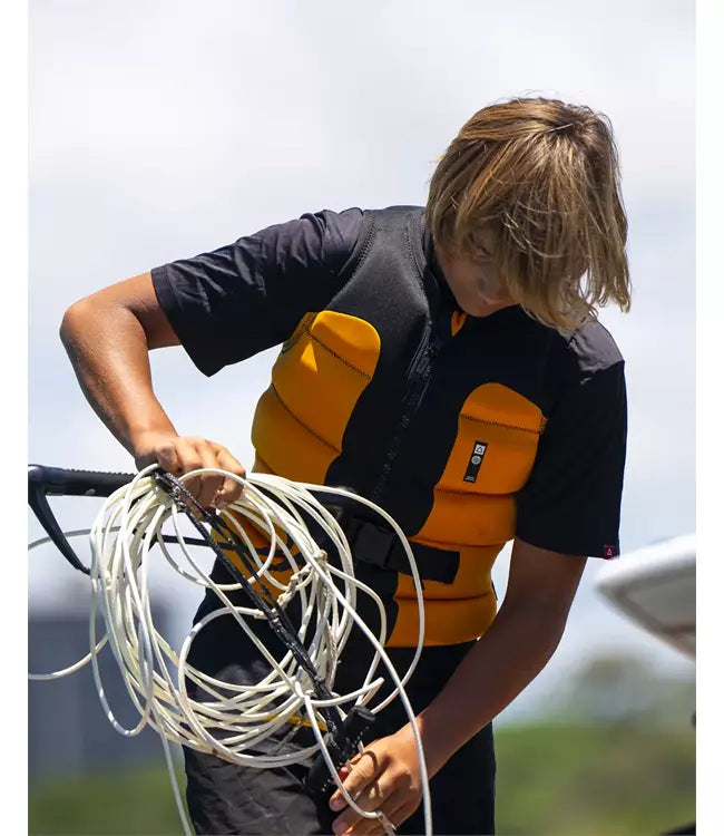 Follow Global Youth Orange Life Vest worn by a teen rider during a session behind the boat