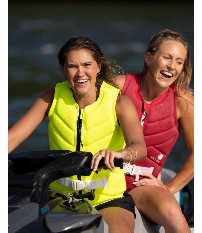Follow Atlantis L50 Yellow Womens Life Vest worn by a jetski rider on partially smooth water