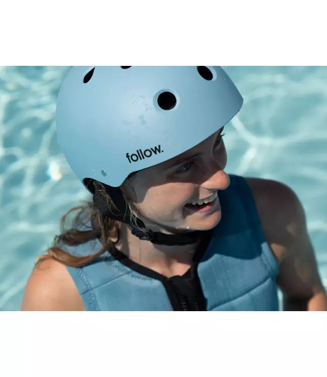 Follow Safety First Wake Helmet Ocean worn by a rider at the cable park on a wakeboard