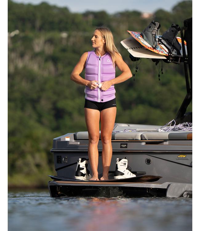 Follow Corp Purple Womens Life Vest worn by a woman wakeboarding behind the boat