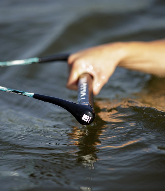 Follow Team Package Teal/Hex wakeboard rope and handle in use behind the boat on open water