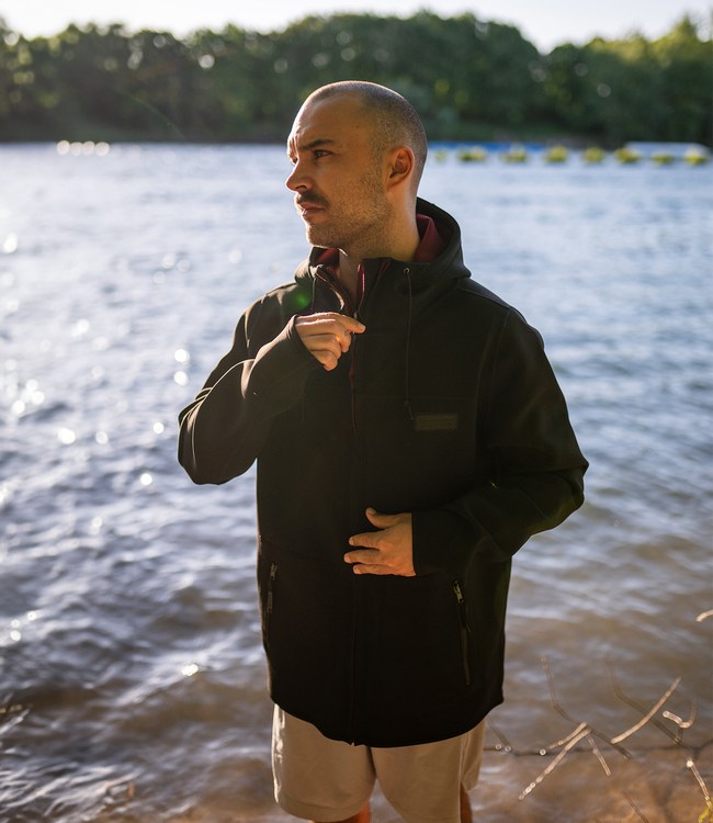 Follow P1 Control Neo Jacket Black worn by a rider staying warm on the boat between sets