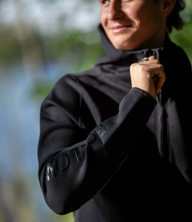 Follow Company Neo Jacket Black worn by a rider staying warm between sets on the boat