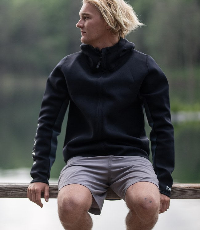 Follow Company Neo Jacket Black worn by a rider on the water during an early session