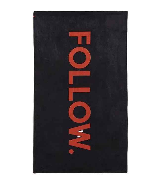 Follow Towel Black - studio view of the quick-dry microfibre water sports towel with logo