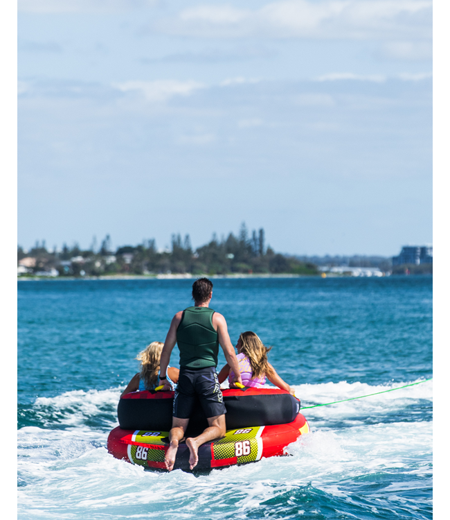 Jetpilot Freeride 3 Person Ski Tube lifestyle shot of riders mid-tow behind boat