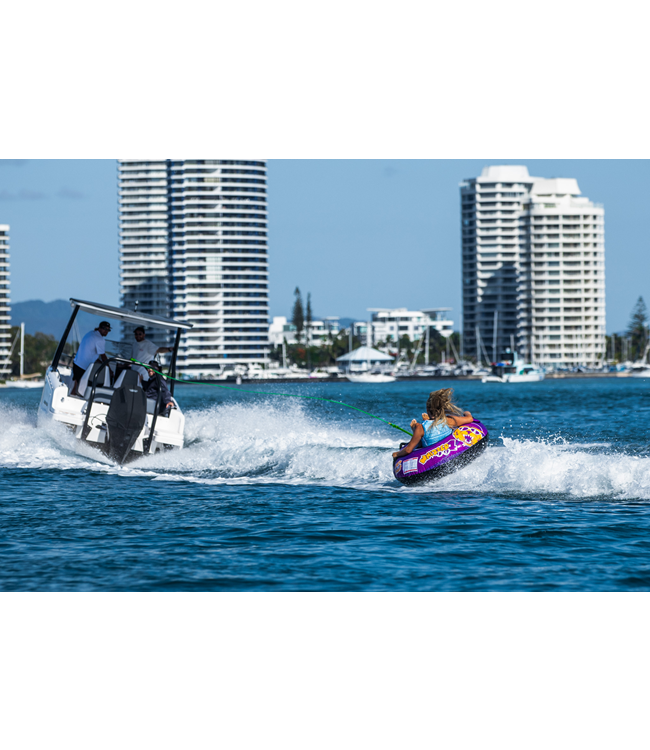 Jetpilot Whizzer 1 Person Ski Tube lifestyle shot of rider mid-tow behind boat on lake