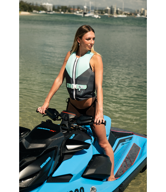 Jetpilot Cause Teal Womens Life Vest lifestyle portrait near boat at sunset with rider