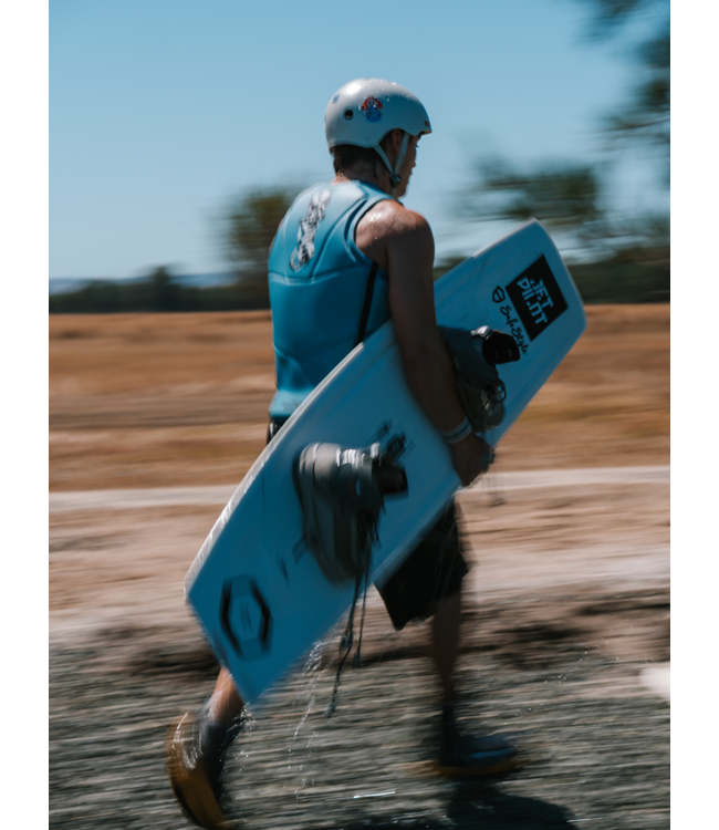 Jetpilot X Heatley Steel Blue Mens Life Vest on-water wakeboard action shot with full torso visible