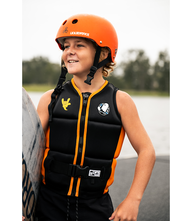 Jetpilot Freeride Black Boys Life Vest worn lifestyle shot of young rider on dock