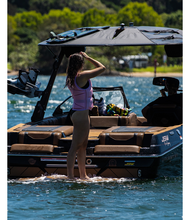 Jetpilot Allure Pink Womens Life Vest on-water wakeboard action shot showing panel flex