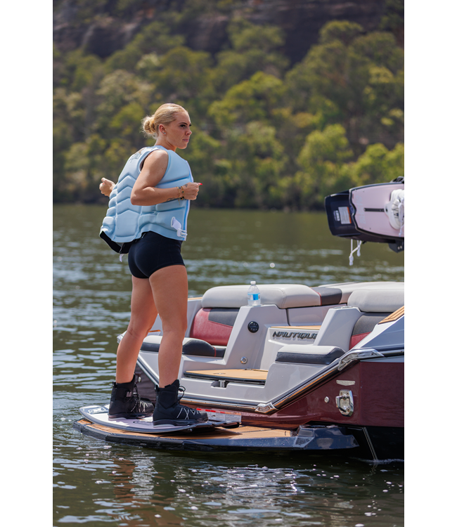 Jetpilot Zahra X1 Ice Blue Womens Life Vest female rider lifestyle close shot near boat