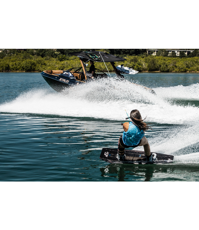 Jetpilot Luna X1 Blue Womens Life Vest mid wakeboard action with full body movement shown