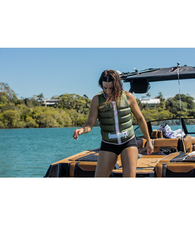 Jetpilot Luna X1 Olive Ladies Life Vest worn alternate angle near boat showing vest cut