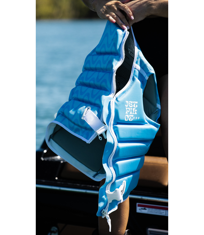Jetpilot Luna X1 Blue Womens Life Vest worn lifestyle shot of female rider near boat dock