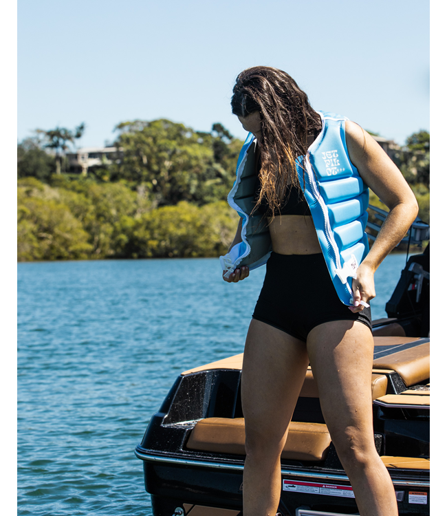 Jetpilot Luna X1 Blue Womens Life Vest on-water wakeboard action shot showing panel flex