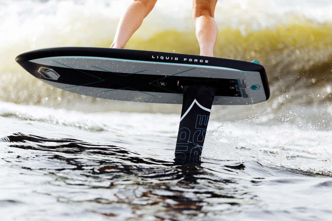 Liquid Force X Foil Board flying above the water on the foil behind the boat