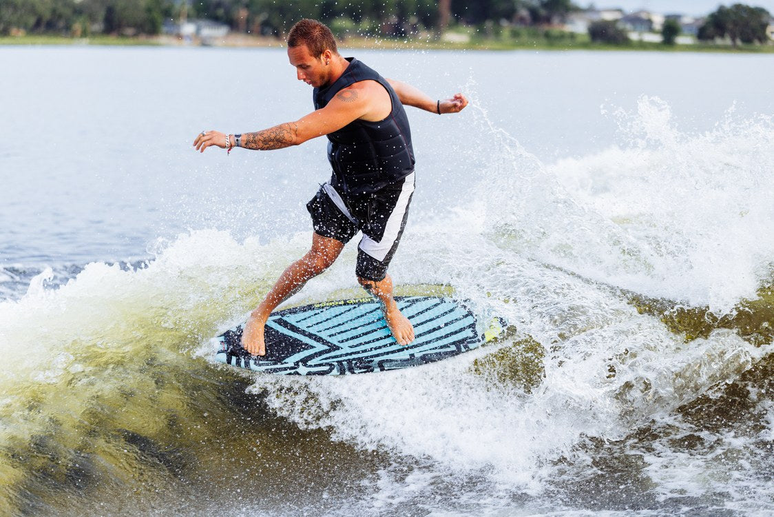 Liquid Force Ace Skim Wakesurfer on a rider spinning the board on the face of the wave