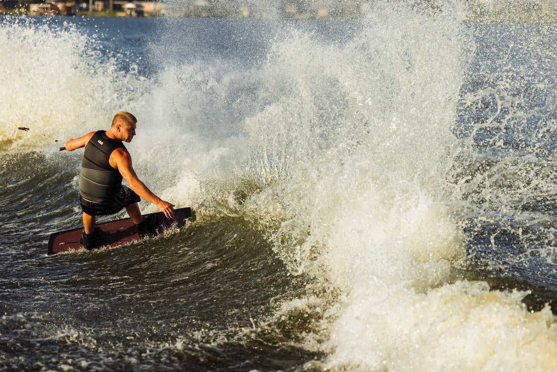 Liquid Force Origin Aero Wakeboard Package on a rider cutting toward the wake