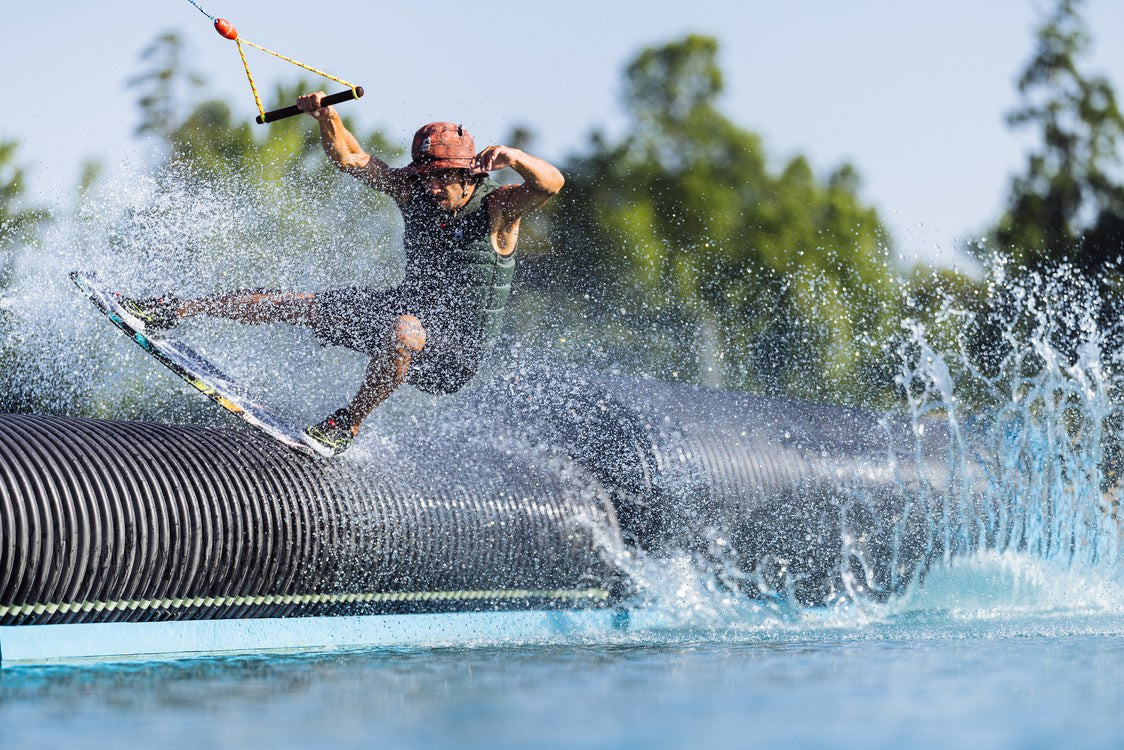 Liquid Force Tao Wakeskate on a rider sliding a rail feature at the cable park