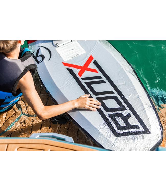 Ronix 727 Foil Board - rider crouched on the dock rigging the foil board over green water