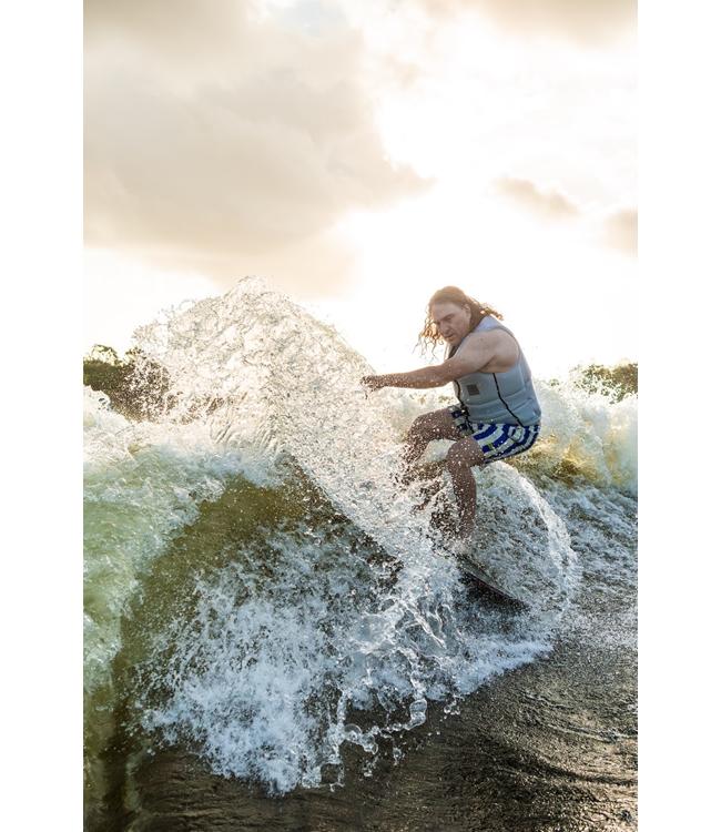Ronix M50 Dark Matter Wakesurfer - rider snapping off the top into a wall of backlit spray