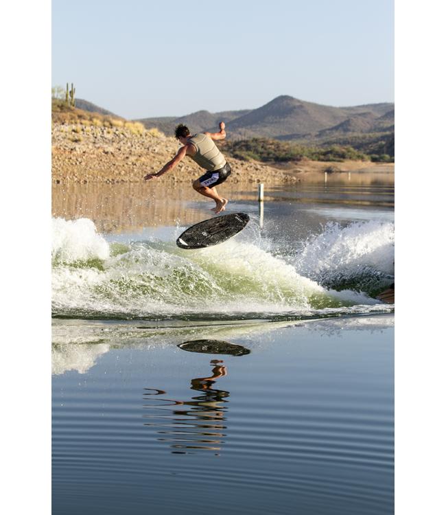 Ronix Osmo Skimmer - rider popping an air off the wake with desert hills and cactus behind