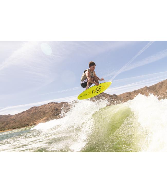 Ronix Osmo Skimmer Tuff Tech - rider crouched on the fluoro yellow board off the top of the wave