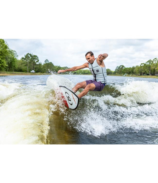 Ronix South Shore Skimmer - rider laid over through a bottom turn with spray off the rail