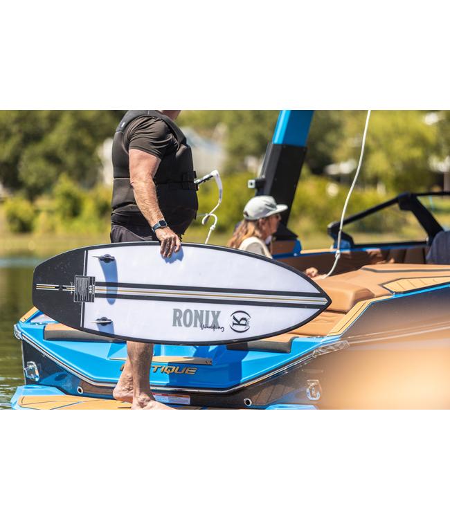 Ronix Wave King Wakesurfer - rider carrying the board past the back of the boat